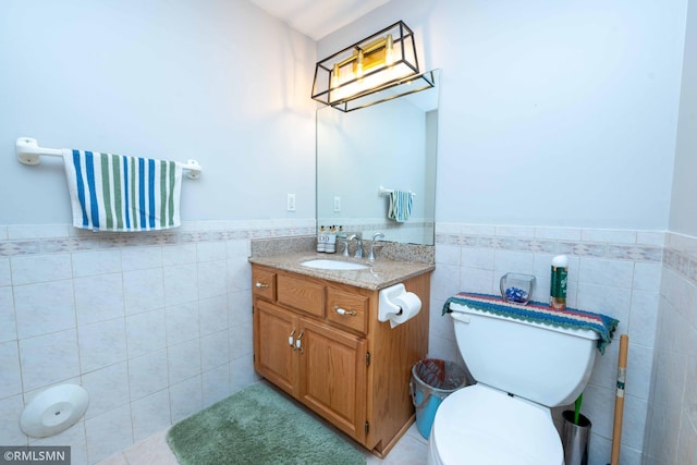 155 Palomino Ln, Lino Lakes, MN 55014 - bathroom featuring tile walls, vanity, wainscoting, and toilet