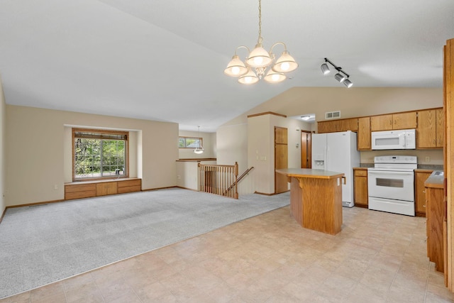 kitchen with white appliances, vaulted ceiling, a chandelier, light countertops, and rail lighting