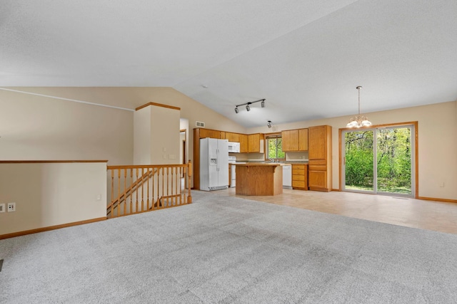 unfurnished living room featuring lofted ceiling, a chandelier, baseboards, and light colored carpet