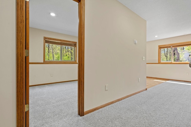spare room with carpet flooring, baseboards, and recessed lighting