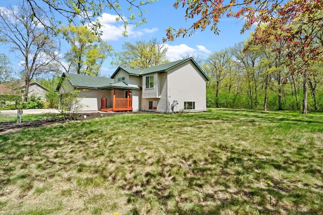 rear view of house featuring a lawn