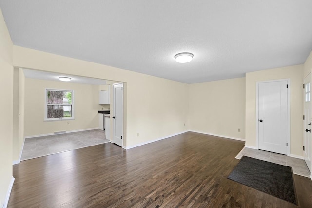 2756 Sunset Ln, Burnsville, MN 55337 - unfurnished living room featuring dark wood-style flooring and baseboards