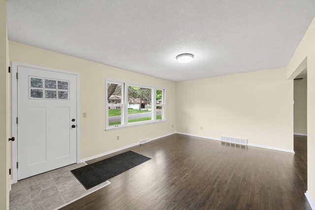 2756 Sunset Ln, Burnsville, MN 55337 - foyer featuring baseboards, wood finished floors, and a textured ceiling