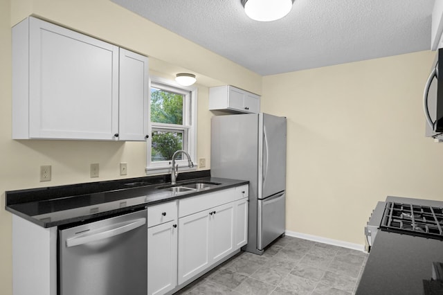 2756 Sunset Ln, Burnsville, MN 55337 - kitchen featuring appliances with stainless steel finishes, a sink, white cabinets, and a textured ceiling