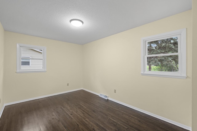 2756 Sunset Ln, Burnsville, MN 55337 - empty room featuring dark wood finished floors, baseboards, and a textured ceiling