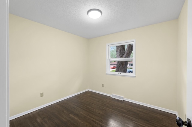 2756 Sunset Ln, Burnsville, MN 55337 - empty room featuring baseboards, dark wood-type flooring, and a textured ceiling