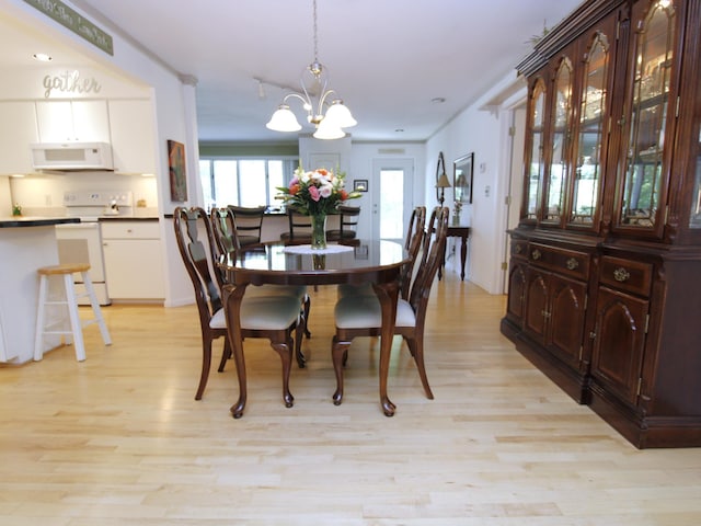dining space featuring a chandelier and light wood-style floors