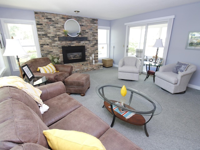 carpeted living area with a brick fireplace and baseboards