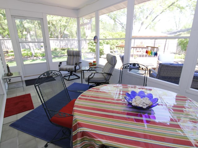 sunroom with outdoor dining space