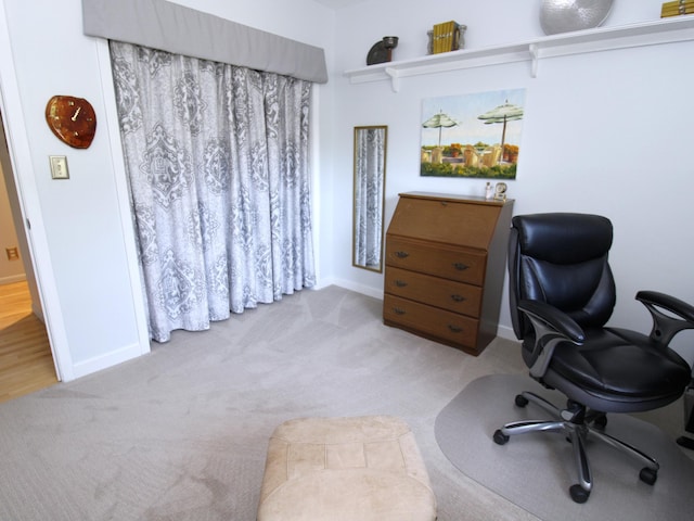 carpeted home office featuring baseboards