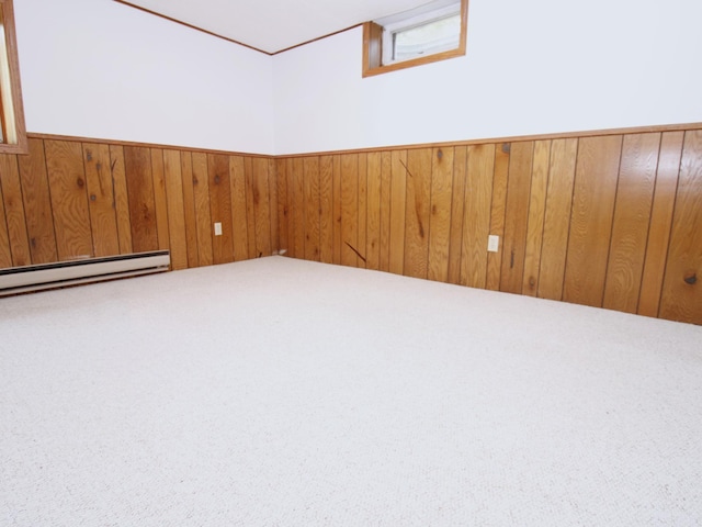 carpeted spare room with wood walls and a wainscoted wall