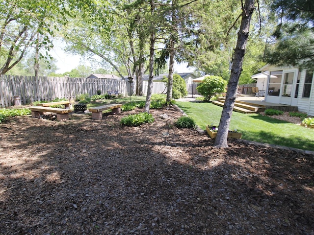 view of yard with a deck and a sunroom