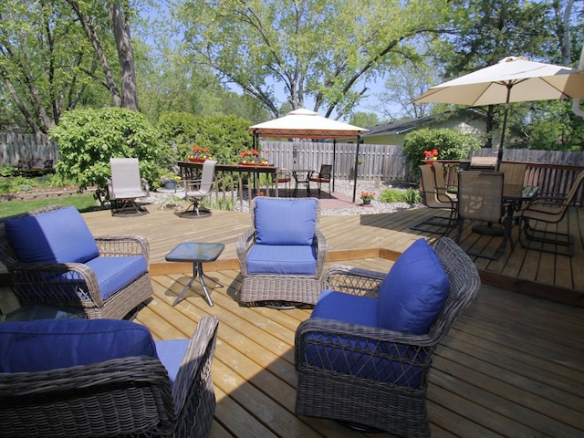 wooden terrace with outdoor dining space and a fenced backyard