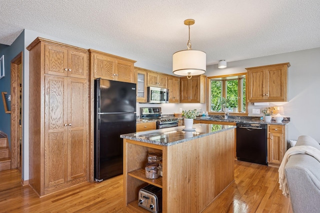 10547 Hollister Ave NW, Maple Lake, MN 55358 - kitchen featuring black appliances, light wood-style flooring, a textured ceiling, a kitchen island, and dark stone countertops
