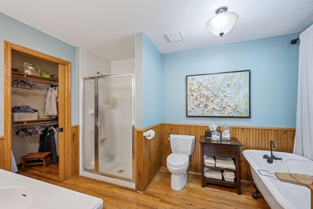 10547 Hollister Ave NW, Maple Lake, MN 55358 - bathroom featuring a shower stall, wainscoting, wood finished floors, a sink, and a freestanding bath