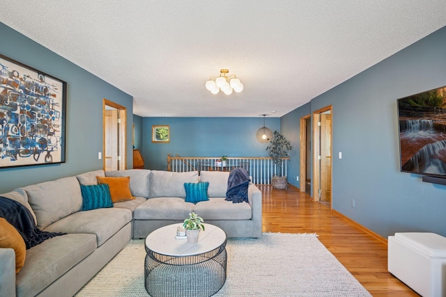 10547 Hollister Ave NW, Maple Lake, MN 55358 - living room with wood finished floors, a textured ceiling, and baseboards