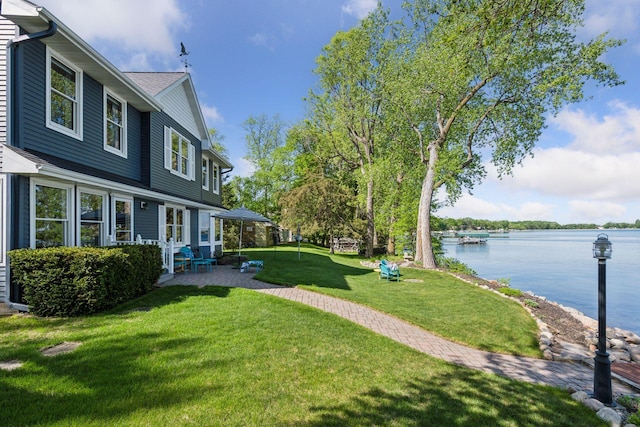 10547 Hollister Ave NW, Maple Lake, MN 55358 - view of grassy yard with a water view and a patio