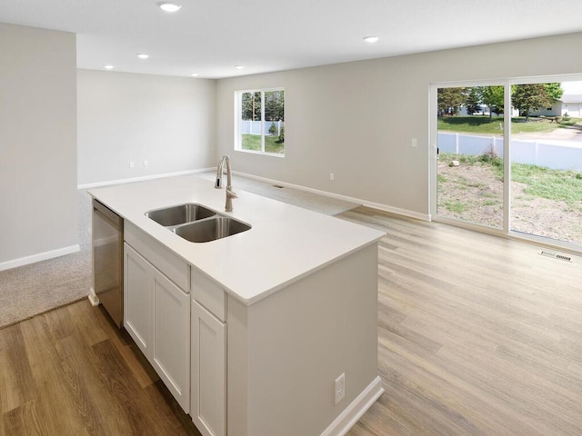 kitchen featuring a sink, dishwasher, open floor plan, baseboards, and recessed lighting