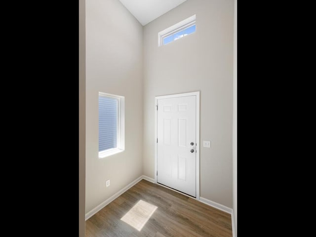 foyer with wood finished floors and baseboards