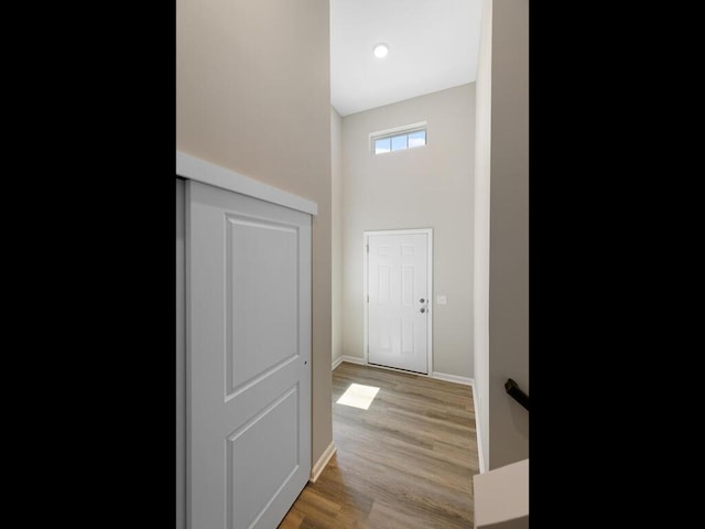 hallway featuring baseboards and wood finished floors