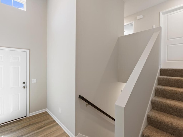 foyer with light wood-style flooring and baseboards