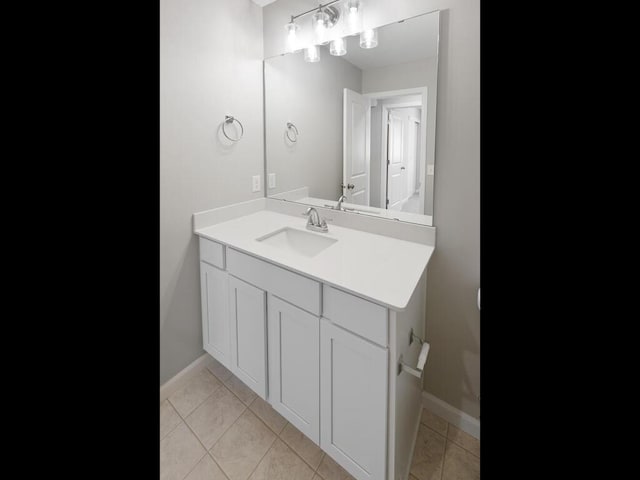 bathroom featuring baseboards, vanity, and tile patterned flooring