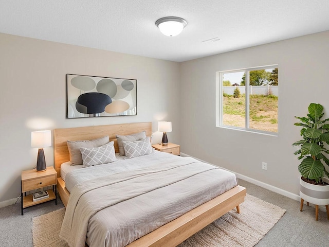 carpeted bedroom with baseboards
