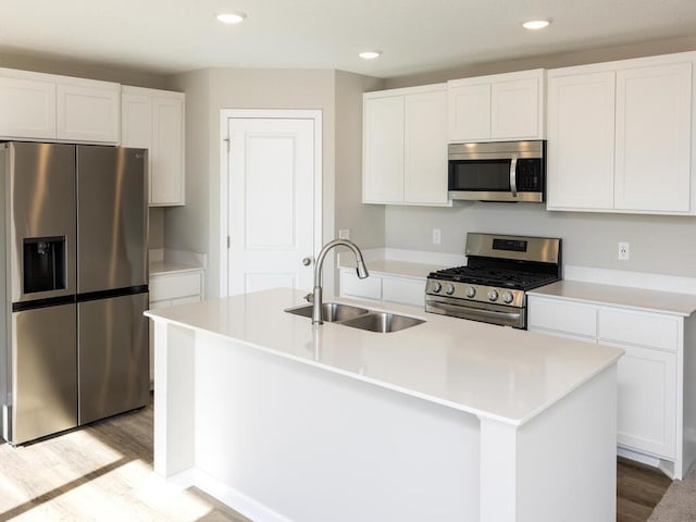 3216 Kady Ave NE, Saint Michael, MN 55376 - kitchen with appliances with stainless steel finishes, a sink, light wood-style floors, white cabinetry, and recessed lighting