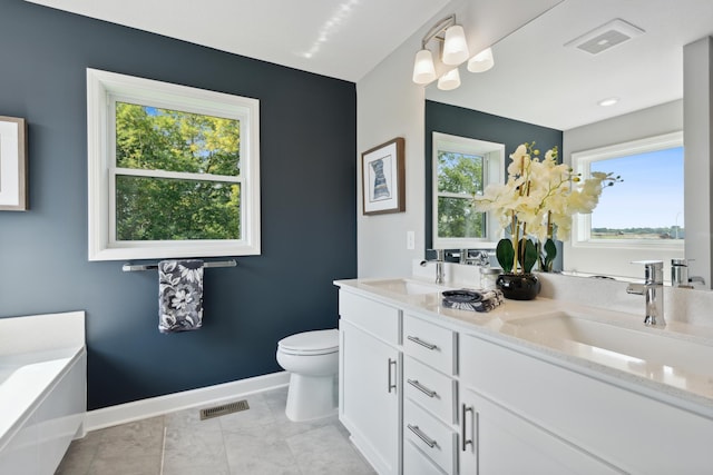 9587 Jada Way, Elko New Market, MN 55020 - full bath with healthy amount of natural light, toilet, baseboards, and double vanity