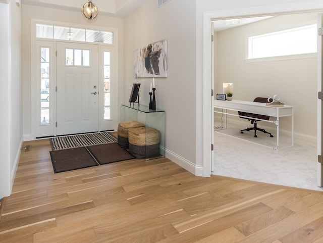 entrance foyer with light wood-type flooring and baseboards