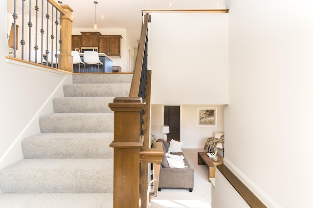 staircase with baseboards, carpet, and recessed lighting