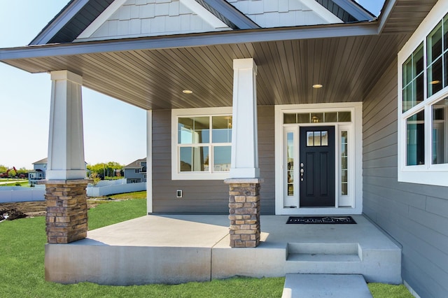 view of exterior entry with a porch