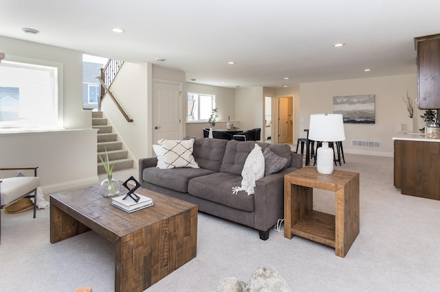 living area with light colored carpet, stairs, recessed lighting, and baseboards