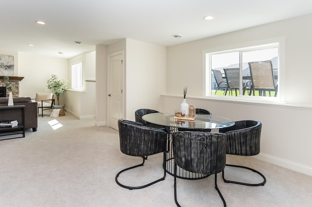 dining space featuring carpet, baseboards, a fireplace, and recessed lighting