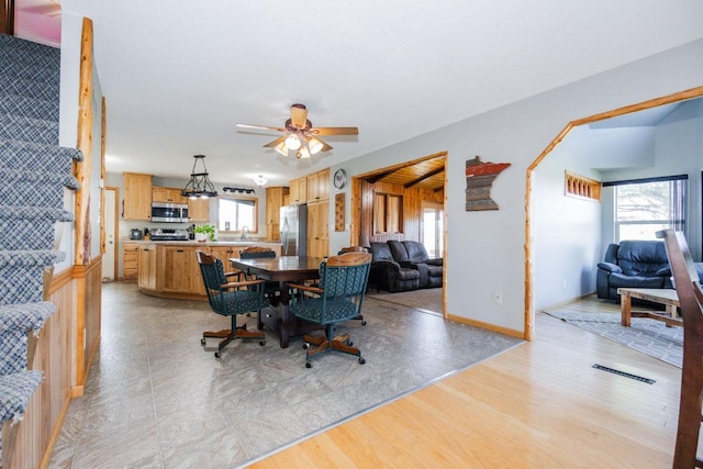 35445 County Highway 36, Vergas, MN 56587 - dining area featuring light wood-type flooring, a ceiling fan, stairs, and baseboards