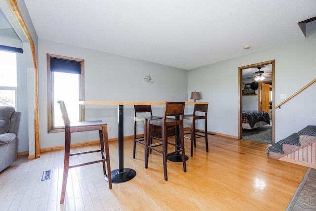 35445 County Highway 36, Vergas, MN 56587 - dining room with wood finished floors, a ceiling fan, stairs, and baseboards