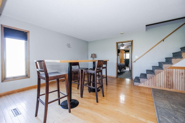 35445 County Highway 36, Vergas, MN 56587 - dining room with stairs, light wood-type flooring, baseboards, and a ceiling fan