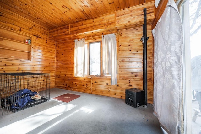 35445 County Highway 36, Vergas, MN 56587 - carpeted empty room featuring wood walls and a wood stove