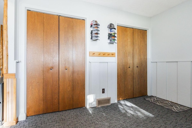 35445 County Highway 36, Vergas, MN 56587 - unfurnished bedroom with carpet, wainscoting, and multiple closets