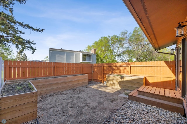 2318 15th St S Unit C11, Fargo, ND 58103 - fenced backyard featuring a vegetable garden