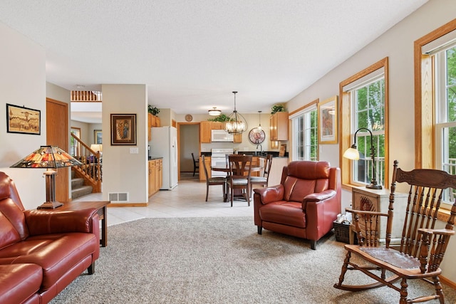 2715 Autumn Woods Dr, Chaska, MN 55318 - living area featuring a chandelier, stairway, light tile patterned floors, light colored carpet, and baseboards