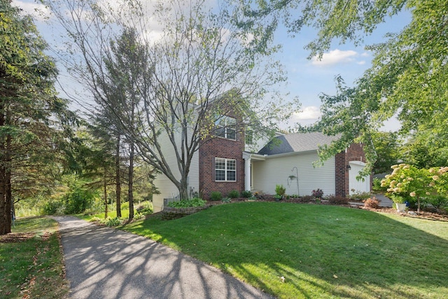 2715 Autumn Woods Dr, Chaska, MN 55318 - view of front facade featuring a front lawn, brick siding, and a garage