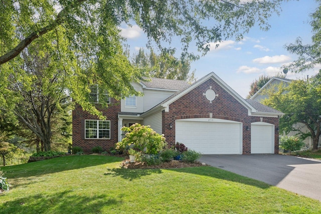 2715 Autumn Woods Dr, Chaska, MN 55318 - traditional-style house featuring an attached garage, brick siding, a front yard, and driveway