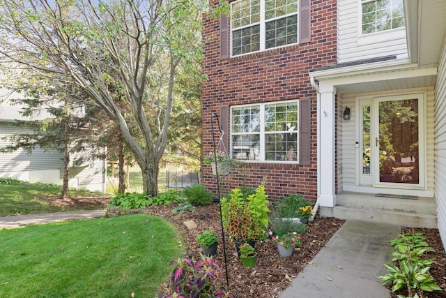 2715 Autumn Woods Dr, Chaska, MN 55318 - doorway to property with brick siding and a yard