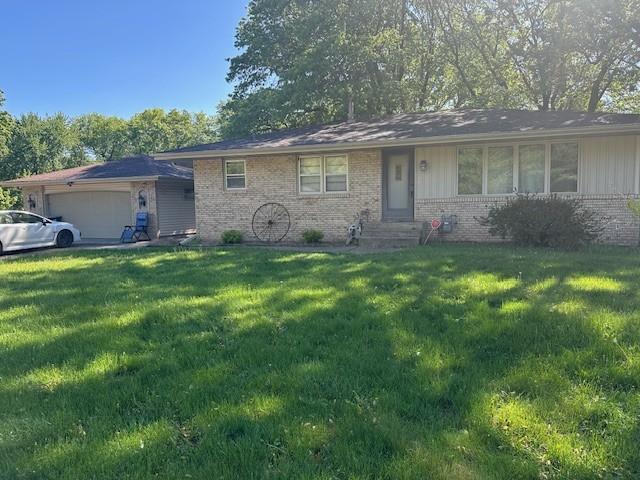14717 Able St NE, Ham Lake, MN 55304 - view of front facade with brick siding, a front lawn, an attached garage, and entry steps
