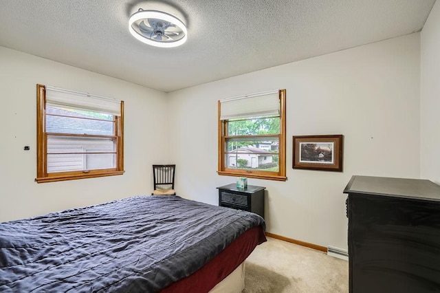 14717 Able St NE, Ham Lake, MN 55304 - bedroom featuring light carpet, multiple windows, a baseboard radiator, baseboards, and a textured ceiling