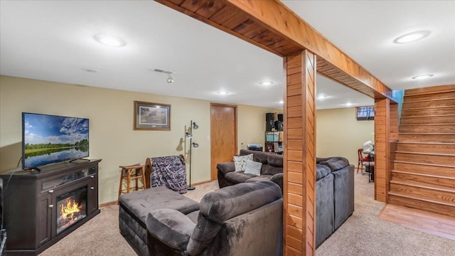 335 Cossairt Ave W, Eden Valley, MN 55329 - carpeted living area featuring stairs, baseboards, a glass covered fireplace, and recessed lighting