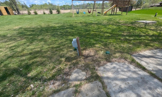 view of grassy yard featuring a playground