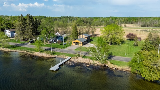 drone / aerial view of a large body of water and a heavily wooded area