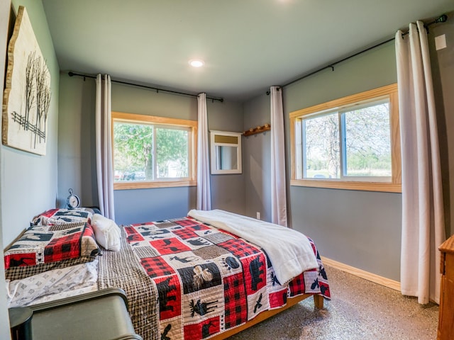 bedroom with multiple windows, baseboards, and recessed lighting